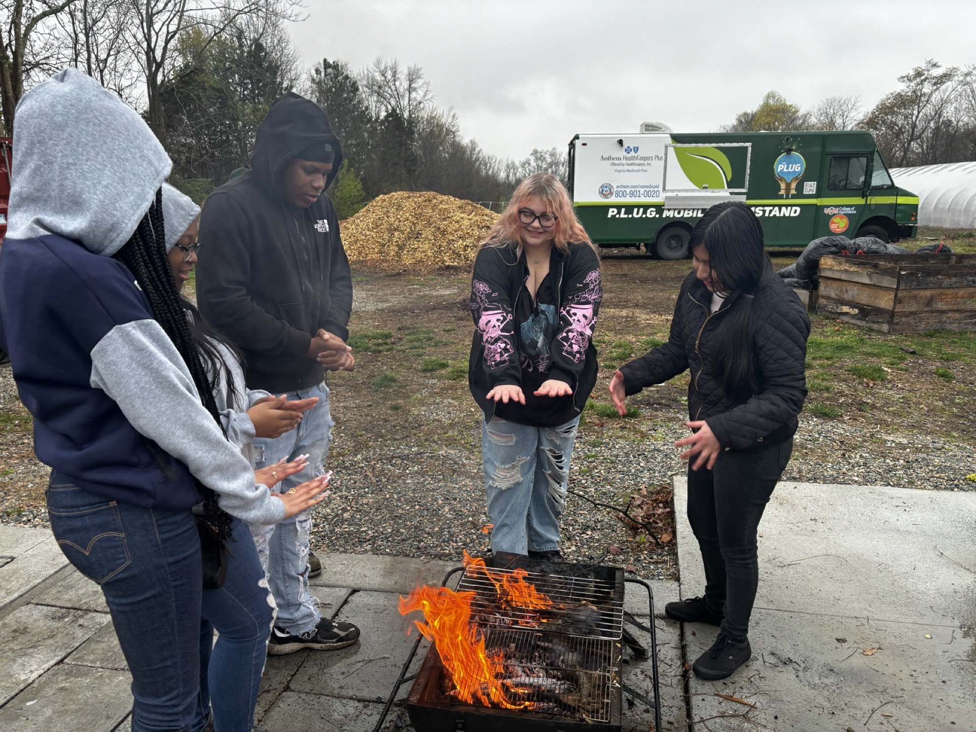 Youth gathered at the farm beside the P.L.U.G. Mobile FarmStand