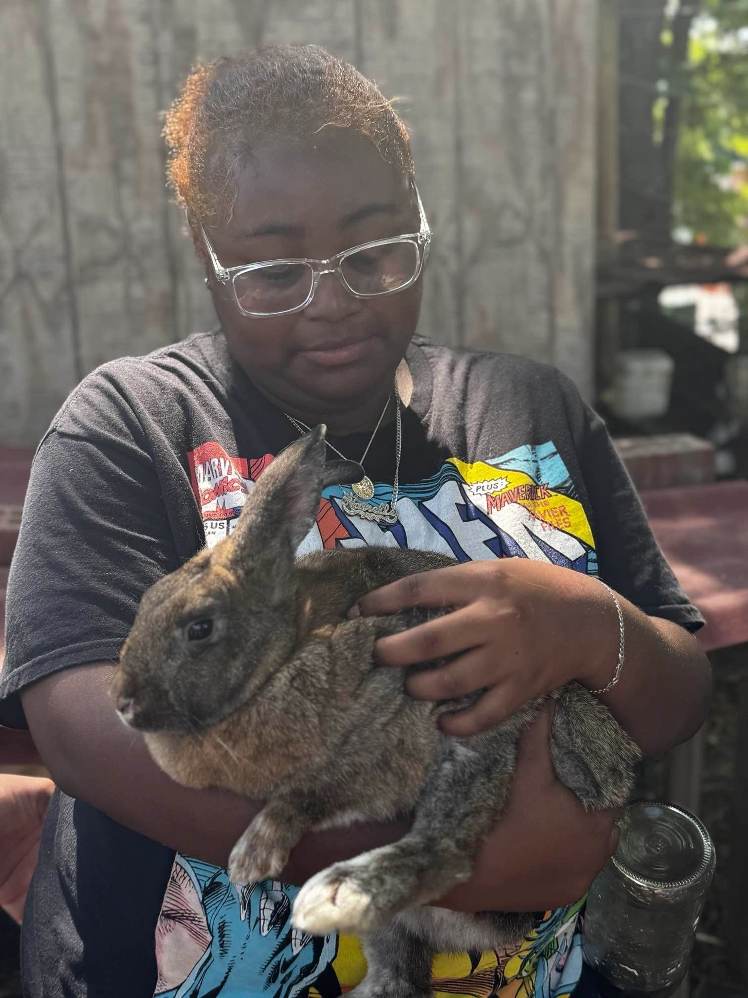 A young grower holding a rabbit