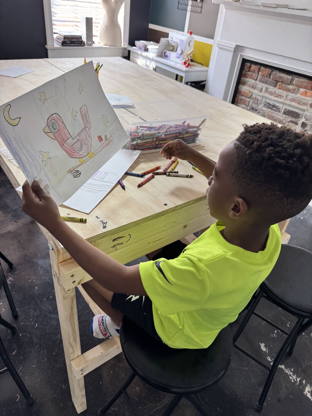 A young grower working on an art piece at the table